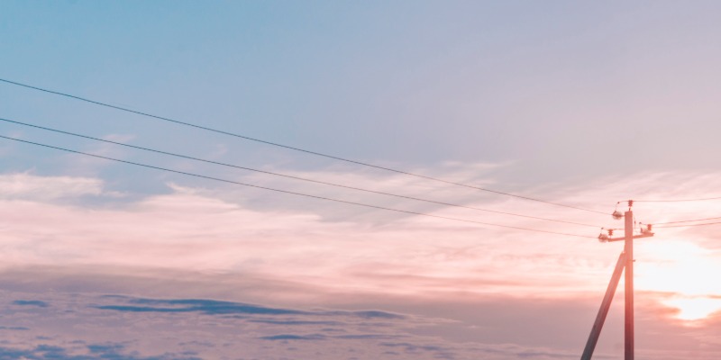 Beautiful landscape with a utility pole and clouds in the background
