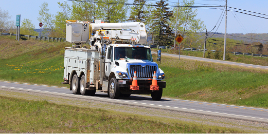 Electrical Truck driving down a road
